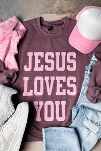 Maroon sweatshirt with 'Jesus Loves You' text in light pink. 